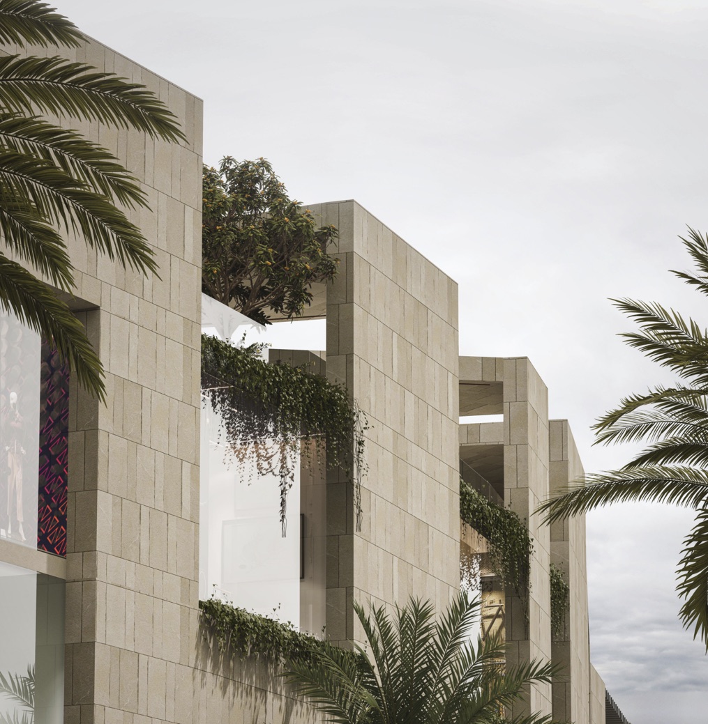 Stone-clad walls with hanging greenery and a tree on the terrace, seen against a cloudy sky between palms